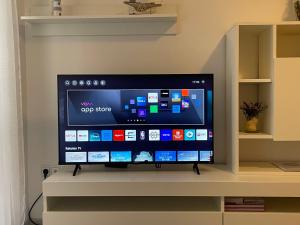 a flat screen tv sitting on top of a shelf at Apartman Buccari in Bakar