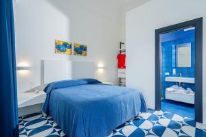 - une chambre avec un lit bleu et un lavabo dans l'établissement Villa Azzurra, à Vico Equense