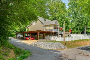 a house with a car parked in front of it at Modern Tims Ford Lake Home with Private Dock and Pool! in Lynchburg