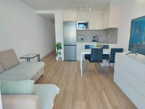 a living room with a couch and a table at Beach Home San Agustín in San Bartolomé