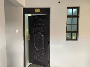 a black elevator door in a white wall at Riiri Heights Ong'ata Rongai in Ongata Rongai 