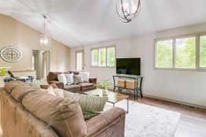 a living room with two couches and a tv at Spacious Massanutten Home with Hot Tub and Sauna! in McGaheysville