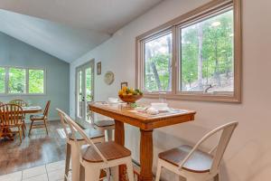 a dining room with a table and chairs in a room at Spacious Massanutten Home with Hot Tub and Sauna! in McGaheysville
