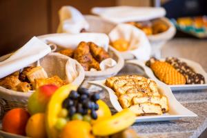 a table topped with baskets of different types of food at Wyndham Cluj in Cluj-Napoca +63 photos