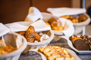 a bunch of baskets filled with different types of pastries at Wyndham Cluj in Cluj-Napoca