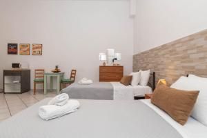 una camera d'albergo con due letti e asciugamani di Dora's Apartments a Laganas