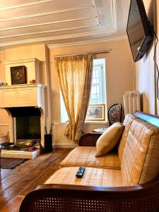 a living room with a couch and a fireplace at Mary’s Zagori boutique home in Ano Pedina