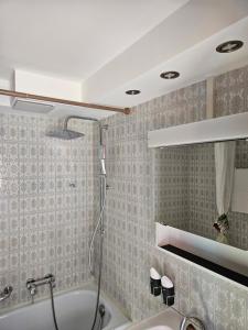 a bathroom with a shower and a bath tub at Apartment Klein Matterhorn - Haus Miranda in Täsch