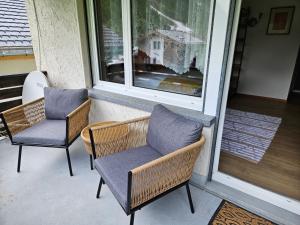 two chairs and a window on a porch at Apartment Klein Matterhorn - Haus Miranda in Täsch