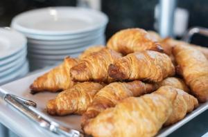 a tray of croissants and other pastries on a table at Mex Hoteles in Cancún