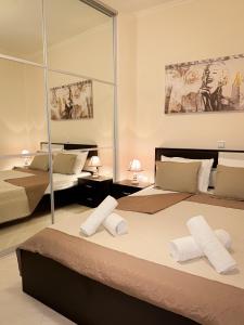 two beds in a room with mirrors at Sun n' Salt I Apartment in Tolo