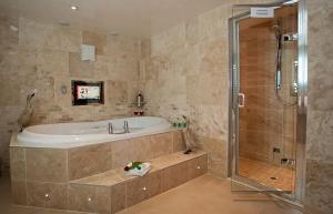 a large bathroom with a tub and a shower at Aphrodites Group in Bowness-on-Windermere
