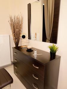 a dresser in a room with a mirror at Sun n' Salt I Apartment in Tolo