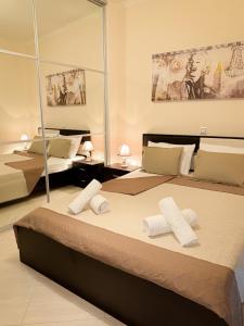 a bedroom with two beds with towels on them at Sun n' Salt I Apartment in Tolo +53 photos