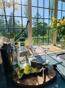 a cutting board with glasses and lemons on a table at Stillmeadow in Westwood