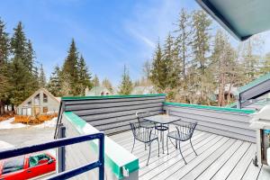 Un patio con sillas y una mesa en una terraza. en Mount Alyeska View Haven, en Girdwood