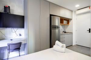 a kitchen with a refrigerator and a chair in it at 360 Vila Mariana in Sao Paulo
