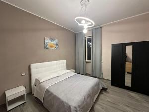 a bedroom with a white bed and a mirror at B&B Mageva Luxury Room in Naples +17 photos