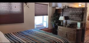 a bedroom with a large bed and a window at 1948 Cottage with today's amenities in Bass Lake Annex