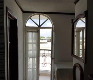 a hallway with an open door to a balcony at Hotel Davinci Calarca in Calarcá