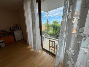 a room with a sliding glass door leading to a patio at Дом за гости ГЕРГАНА in Pleven