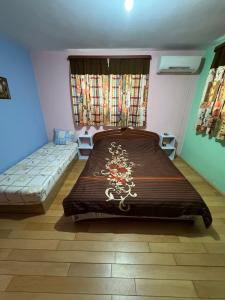 a bedroom with a large bed and a window at Дом за гости ГЕРГАНА in Pleven