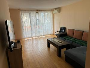 a living room with a couch and a tv at Дом за гости ГЕРГАНА in Pleven