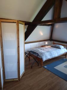a bedroom with a bed in a attic at Gite de Tournieres in Tournières