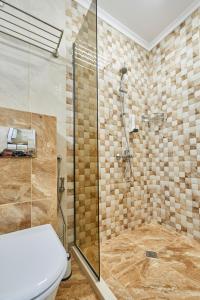 a bathroom with a shower and a toilet at Crotiria Beach - Aparthotel in Pomorie