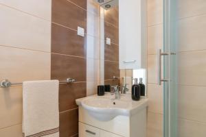 a bathroom with a sink and a mirror at Apartments Josipa in Mandre +96 photos
