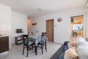 a living room with a table and chairs and a couch at Apartments Josipa in Mandre