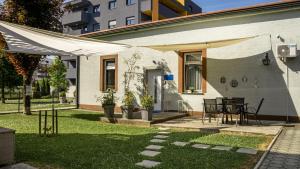 a patio with a table and a white tent at Studioapartment Black & White in Velika Gorica