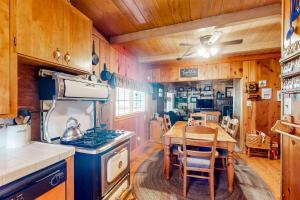 a kitchen with a table and a stove top oven at Mountain Memories in Shaver Lake