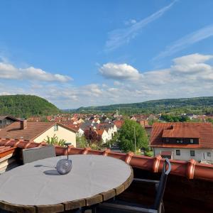 a table on a balcony with a view of a town at auszeit34 in Ebelsbach