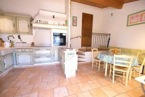 a kitchen with a table and a dining room at pretty detached villa with private swimming pool, in Aureille, in the alpilles - 8 people in Aureille