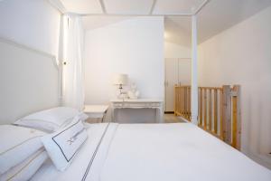 een witte slaapkamer met een wit bed en een bureau bij Diamond Deluxe Hotel - Adults Only in Kos-stad