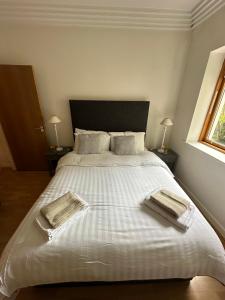 a bedroom with a large bed with two towels on it at The Spencer Suite in Dublin +19 photos