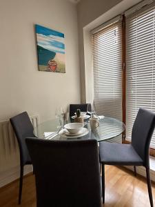 a dining room with a glass table and chairs at The Spencer Suite in Dublin