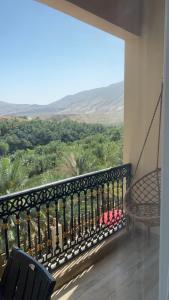 a balcony with a hammock and a view of the desert at WADI BANI KALED REST HOUSE in Dawwah