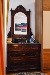 a dresser with a mirror on top of it at Charming marine style apartment in Cres