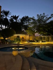 a swimming pool in a yard at night at House of Hathor in Luxor