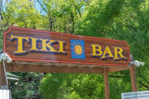 a sign for a bar at a zoo at Geneva Hotel & Tiki Bar in Lake Lure