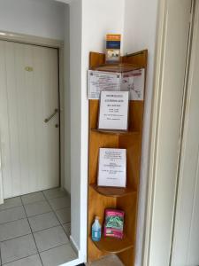 a room with shelves with boxes and a door at Rosmaris Apartments in Plataniás