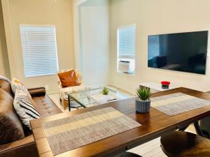 a living room with a couch and a table at Great location in Midtown! in Houston
