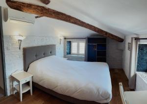 a bedroom with a large white bed and a window at Marina D'oro in Macinaggio