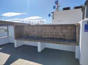 a bench on the side of a building at Apartamento con vistas al mar y montaña in El Verger +1 photo