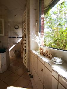 a bathroom with a toilet and a window in it at Seeromantik in Amelinghausen +37 photos