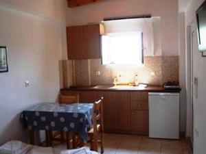 a kitchen with a table and a sink and a window at Studio Stars in Laganas