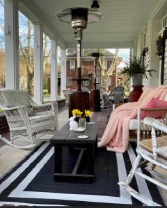 Das Gasthaus, The Inn of Claysburg في Claysburg: شاشة في الشرفة مع وجود طاولة وكراسي