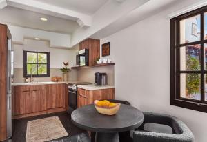 a kitchen with a table with a bowl of fruit on it at Lucille Palm Springs in Palm Springs